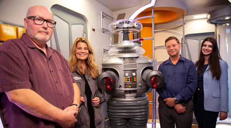 MeTV's "Collector's Call" will share the "Lost in Space" collection of New Carlisle resident Tom Pfrogner on Sunday 
L to R: Expert Doug Hines, host Lisa Whelchel, collector Tom Pfrogner and his daughter Tracie Pfrogner. - Contributed