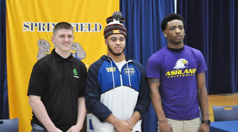Springfield High School seniors (from left) Zach Breslin, Tavion Smith and C.J. McDavid signed to play college football on Wednesday, Feb. 6, 2019. NICK DUDUKOVICH / CONTRIBUTED