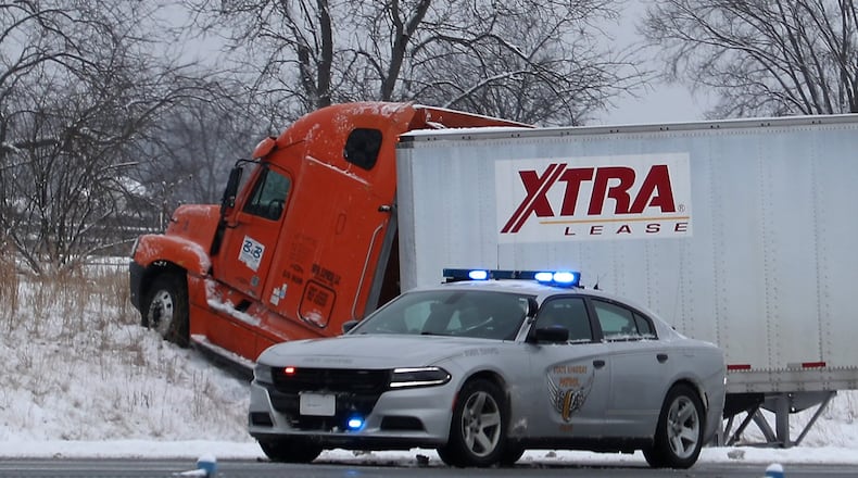 A semi truck closed West bound I-70 near US 68 interchange after the driver lost control and ran off the road causing another truck to run into the back of its trailer Friday morning. BILL LACKEY/STAFF