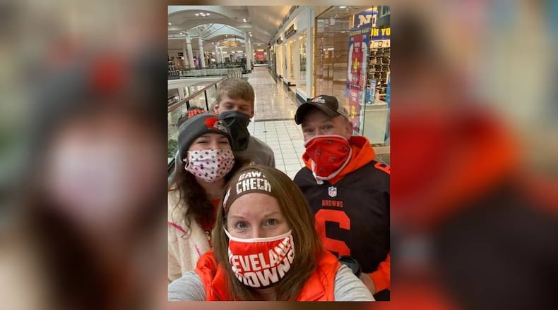 Walking at Fairfield Commons in Browns gear to remember Peter Scarff, Tecumseh Local School District Board of Education member and businessman, before the game Jan. 17. Kassidy Randall Dunham and Trenton Dunham with Sheli and Rusty Randall. Courtesy photo
