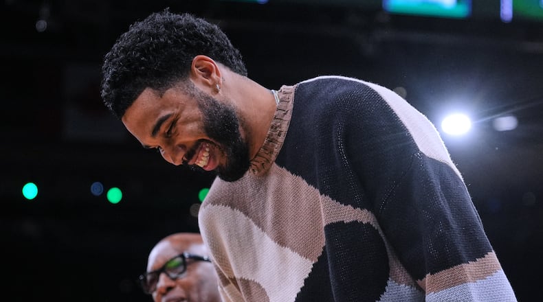 Boston Celtics forward Jayson Tatum, right, jokes with assistant coach Sam Cassell during the first half of an NBA basketball game against the Brooklyn Nets, Friday, Feb. 27, 2026, in Boston. (AP Photo/Charles Krupa)