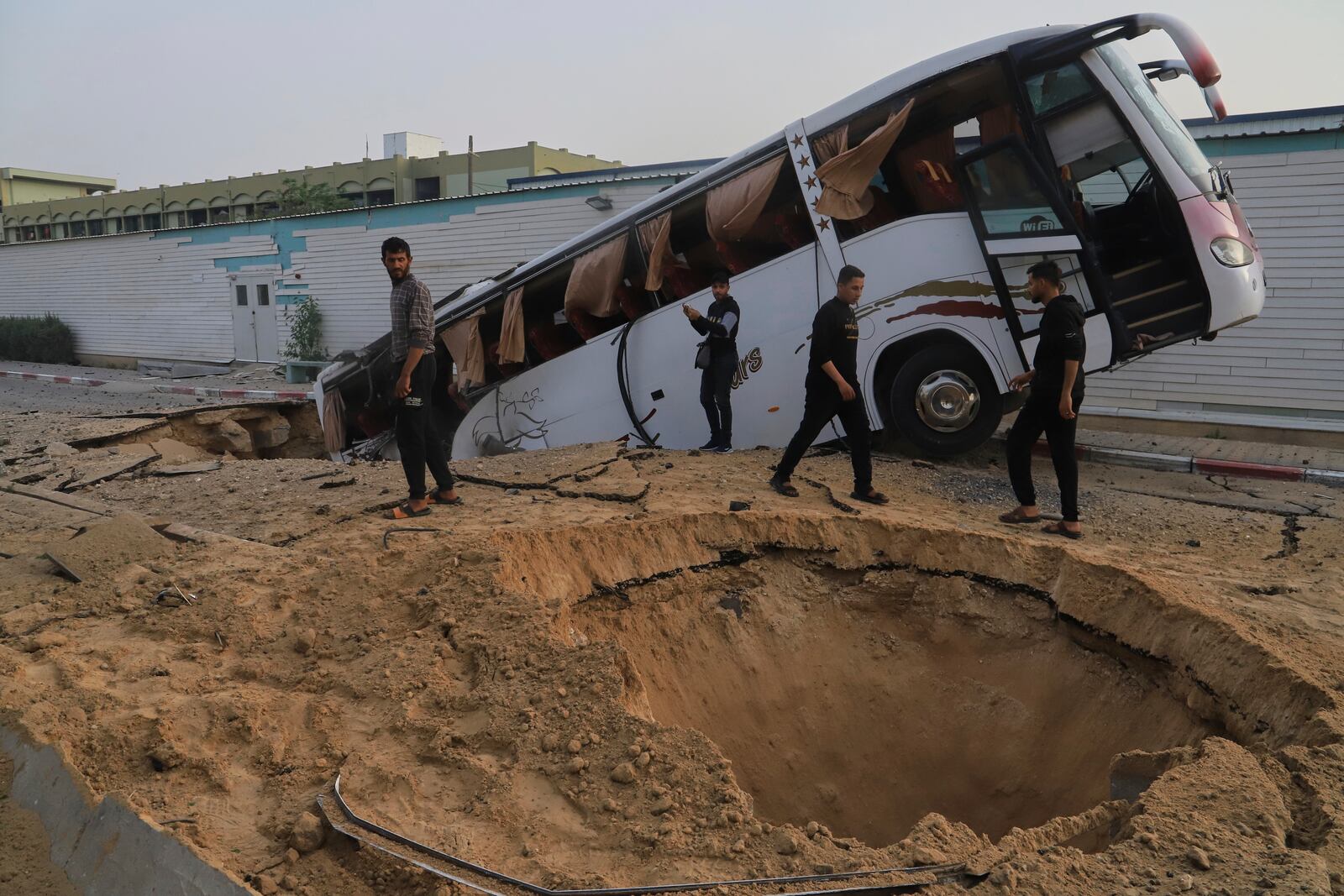 Palestinians inspect the site of an Israeli army airstrike on the European hospital in Khan Younis, Gaza Strip, Tuesday, May 13, 2025. The Israeli military said it had carried out a strike targeting what it said was a Hamas "command and control center" located beneath the hospital. (AP Photo/Mariam Dagga)