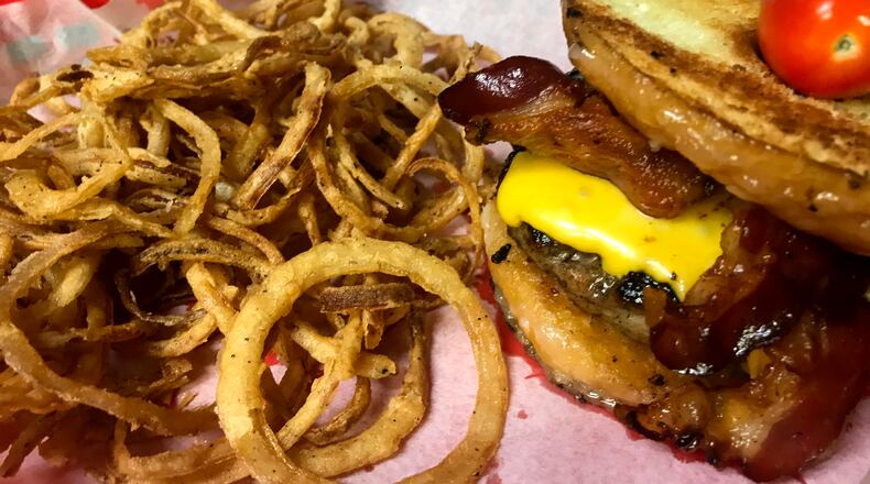 Buckin's Donkey's Porky The Pig Doughnut Burger. Here is is served with house made onion rings.