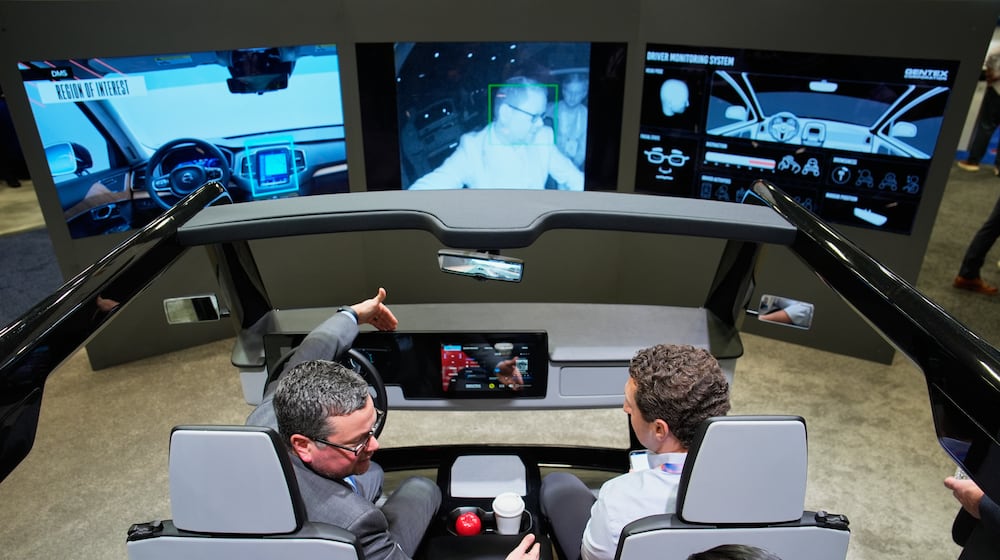 People experience a Gentex Corporation driver and in-camera monitoring system exhibit during the CES tech show Tuesday, Jan. 6, 2026, in Las Vegas. (AP Photo/John Locher)