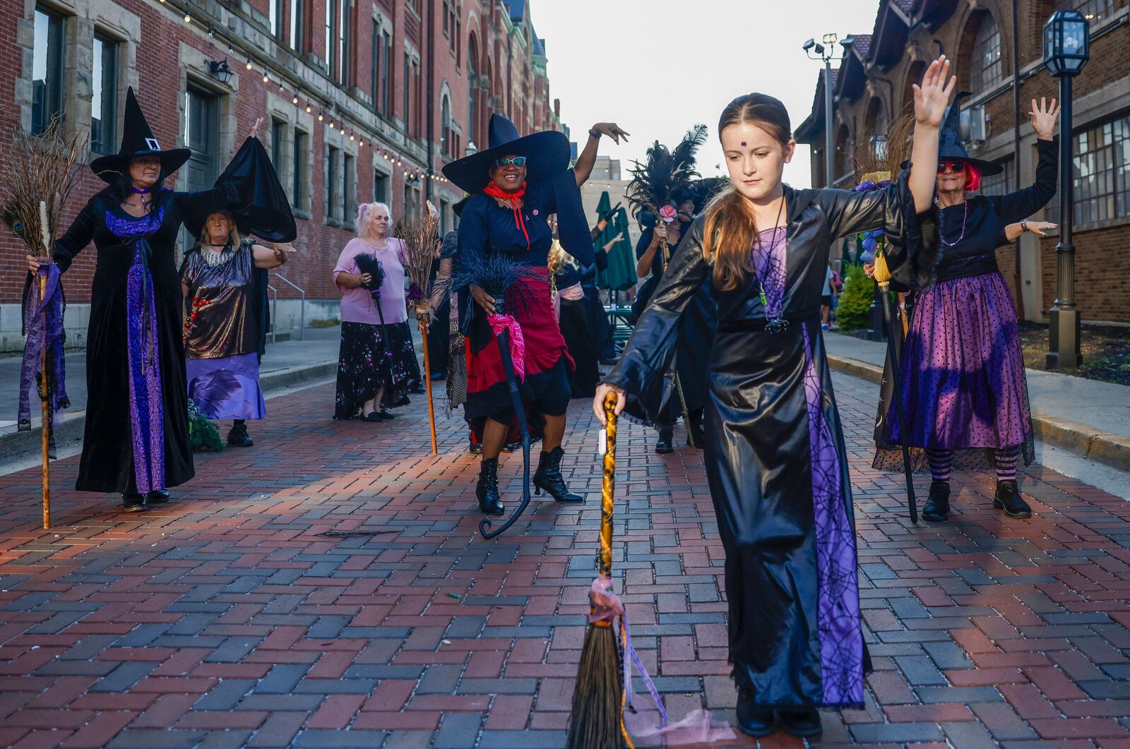 Raven Willow Florence, center, 11, dances with the Rose City Witches outside Myers Market on Friday, Oct. 3, 2025, in Springfield. The performance was part of a Think Pink Foundation event to raise awareness about breast cancer. JOSEPH COOKE/STAFF