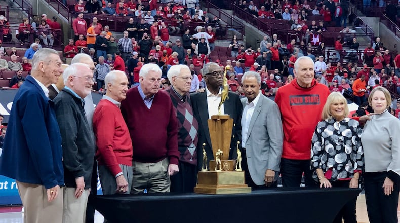 Bob Knight (maroon sweater), Jerry Lucas (third from right) and the rest of the Buckeyes pose with the 1960 national championship trophy at Ohio State in 2020. Marcus Hartman/STAFF