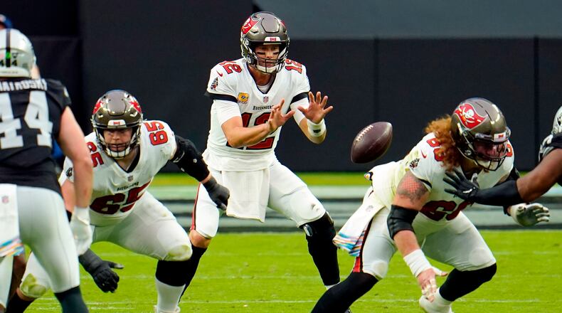 FILE - In this Oct. 25, 2020, file photo, Tampa Bay Buccaneers quarterback Tom Brady (12) receives the ball from center Ryan Jensen (66) during the first half of the team's NFL football game against the Las Vegas Raiders in Las Vegas. “It didn’t take too long, really,” Jensen said of building a rapport with Brady. “We both kind of have a fiery spirit and, you know, I think that has helped us quite a bit, getting to know each other and knowing what we’re about.” (AP Photo/Jeff Bottari, File)