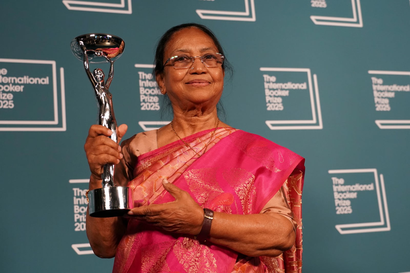 Banu Mushtaq, author of 'Heart Lamp' holds the trophy after winning the International Booker Prize, in London, Tuesday, May 20, 2025.(AP Photo/Alberto Pezzali)