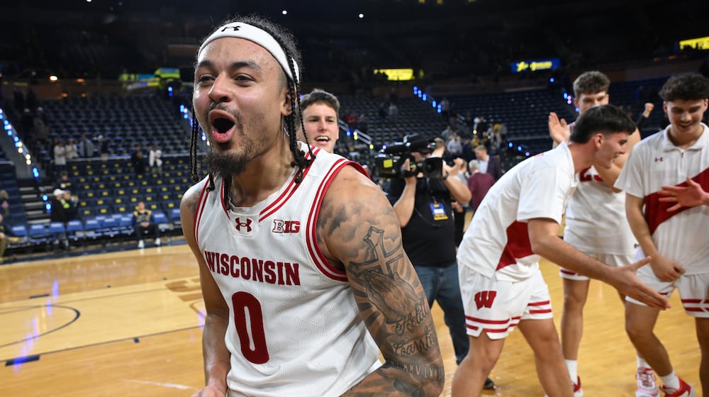 Wisconsin guard Braeden Carrington (0) celebrates with his teammates after they beat Michigan after an NCAA college basketball game in Ann Arbor, Mich., Saturday, January 10, 2026. (AP Photo/Lon Horwedel)