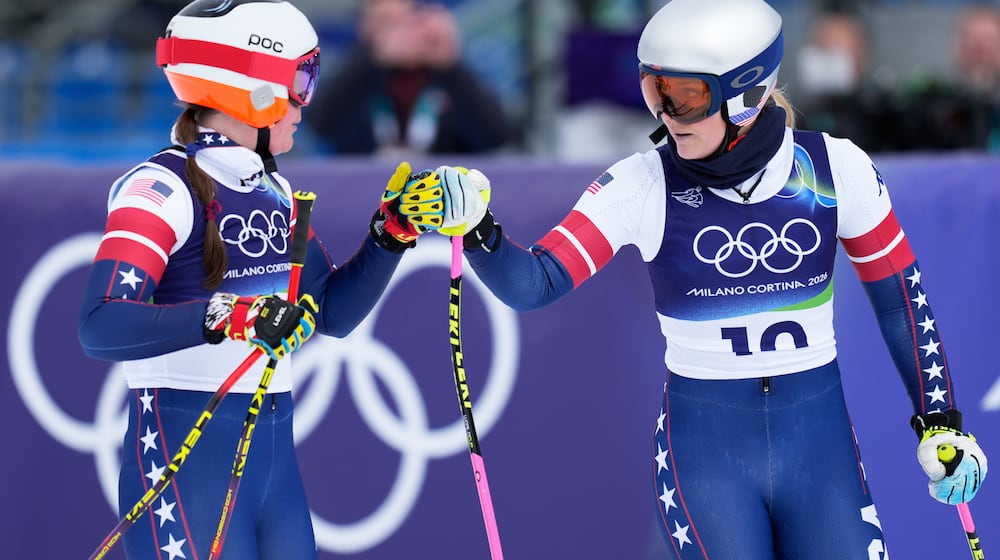 United States' Lindsey Vonn, right, and Breezy Johnson at the finish area during an alpine ski, women's downhill official training, at the 2026 Winter Olympics, in Cortina d'Ampezzo, Italy, Friday, Feb. 6, 2026. (AP Photo/Giovanni Auletta)