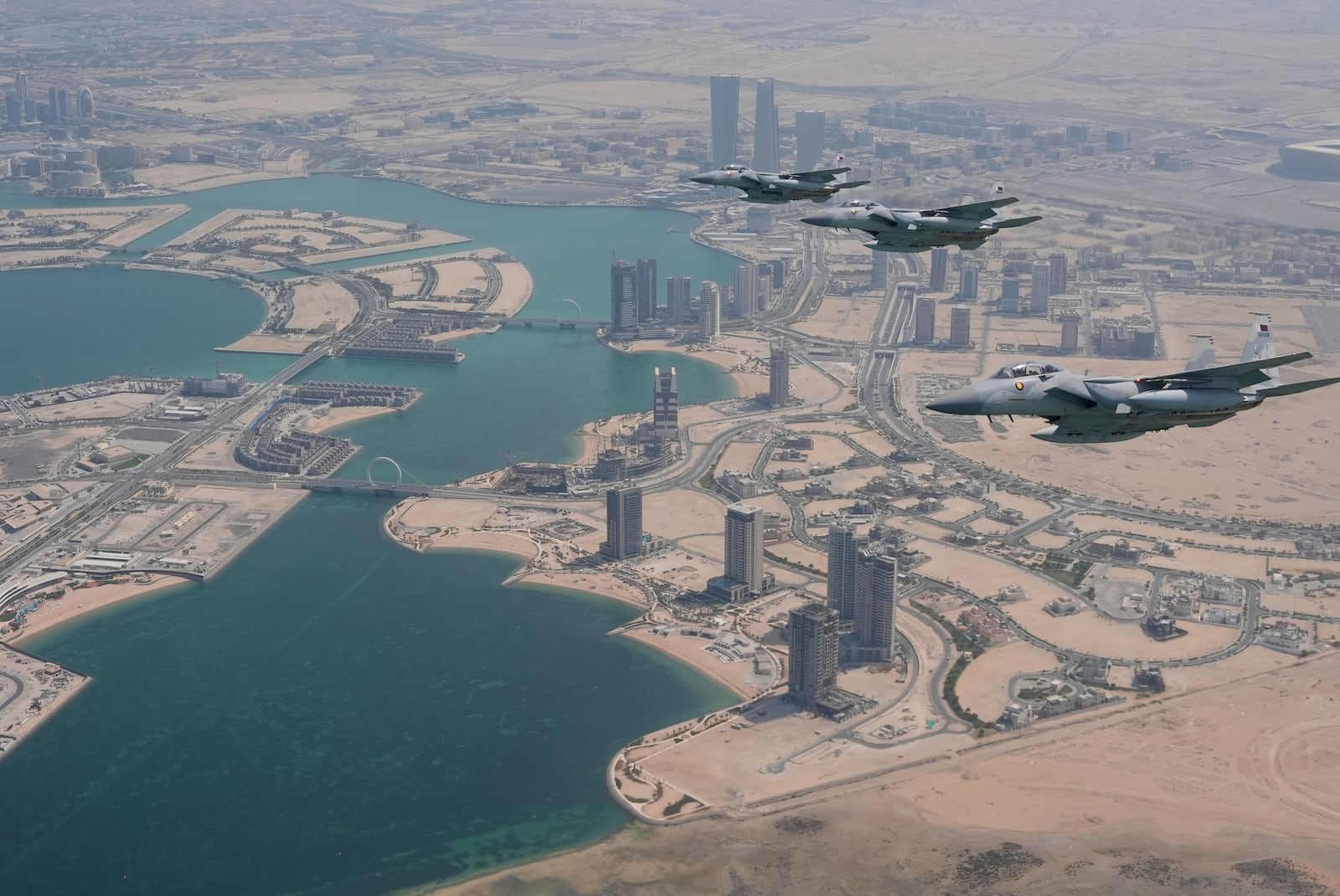 Qatar Emiri Air Force F-15s provide an honorary escort for Air Force One, carrying President Donald Trump, as it arrives in Doha, Qatar, Wednesday, May 14, 2025. (AP Photo/Alex Brandon)