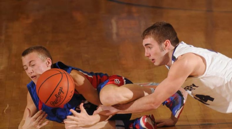 Alec Nix of Greeneview and Ben Dilworth of Fort Recovery battle at mid court for possesion.