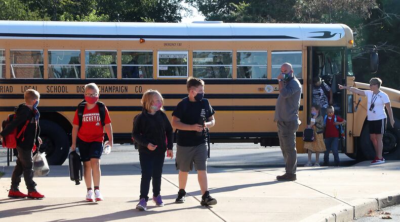 Students prepare to enter Triad Elementary School Thursday for the first day of class. BILL LACKEY/STAFF