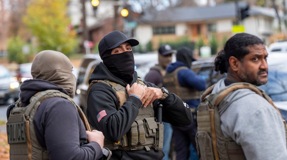 FILE - Federal law enforcement officers with Immigration and Customs Enforcement (ICE) and Enforcement and Removal Operations (ERO) conduct a traffic stop and detain people, Monday, Nov. 17, 2025, in Washington. (AP Photo/Alex Brandon, File)