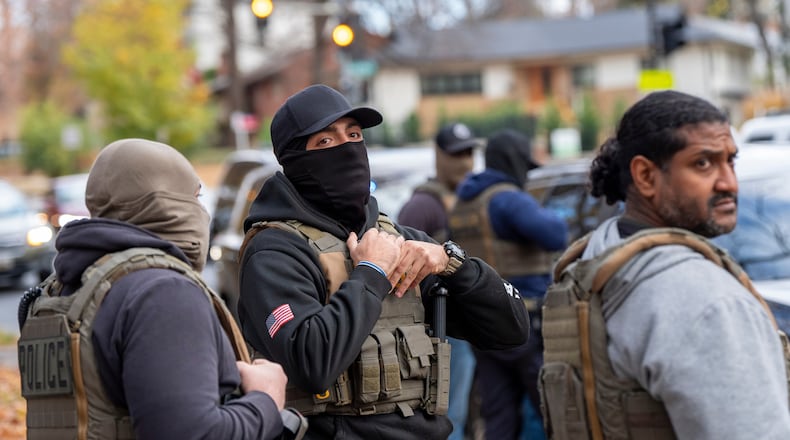 FILE - Federal law enforcement officers with Immigration and Customs Enforcement (ICE) and Enforcement and Removal Operations (ERO) conduct a traffic stop and detain people, Monday, Nov. 17, 2025, in Washington. (AP Photo/Alex Brandon, File)