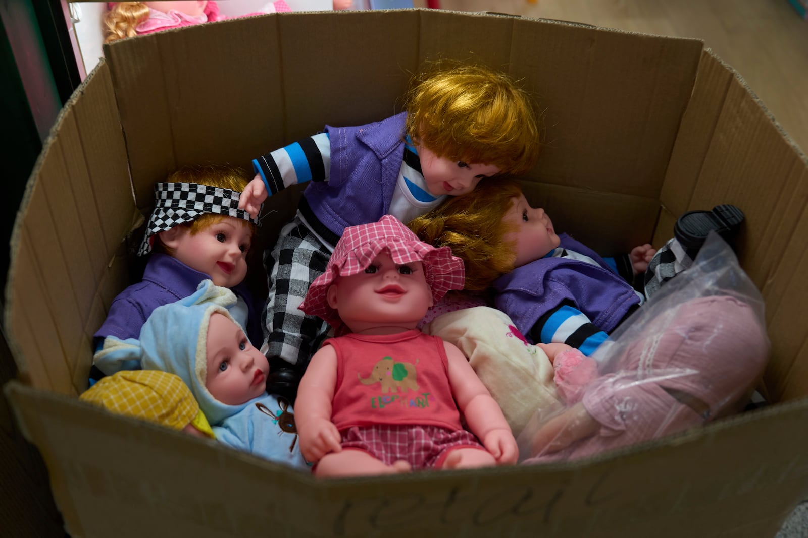 FILE -Dolls are packed in a carton at the Yiwu International Trade Market in Yiwu, eastern China's Zhejiang province, Thursday, April 10, 2025. (AP Photo/Ng Han Guan, File)