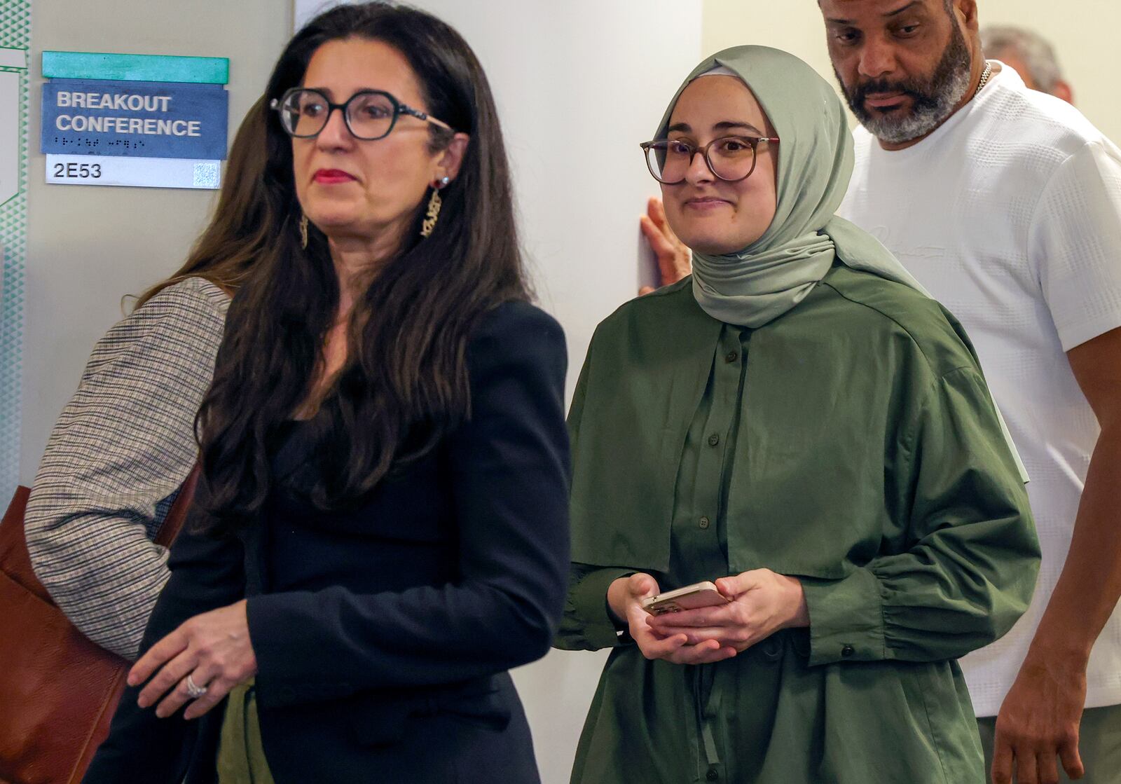 Tufts University student from Turkey, Rumeysa Ozturk, right, who was arrested by immigration agents while walking along a street in a Boston suburb, arrives to talk to reporters about arriving back in Boston, Saturday, May 10, 2025, a day after she was released from a Louisiana immigration detention center on the orders of a federal judge. (Matthew J. Lee/The Boston Globe via AP)