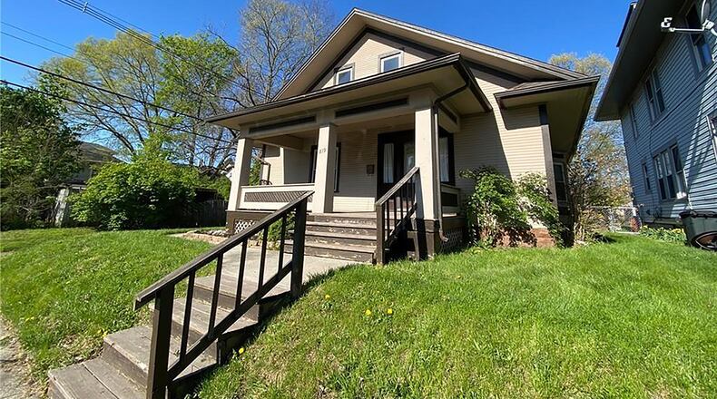The 2-story’s front has a concrete walk leading to wood steps and a covered concrete porch. The 3-bedroom home offers about 1,460 sq. ft. of living space and includes a full, unfinished basement. CONTRIBUTED PHOTO