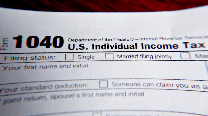 FILE - This Wednesday, Feb. 13, 2019 file photo shows part of a 1040 federal tax form printed from the Internal Revenue Service website, in Zelienople, Pa.  Tax filing season will start a bit later and look a bit different this year. That’s because the pandemic that defined 2020 has seeped into tax time as well. If you worked from home, received a relief payment, took on some gig work or filed unemployment benefits _ or someone filed a fake claim in your name _ there are things you need to be aware of. Likewise if you normally receive certain tax credits. The IRS will begin accepting tax returns on Feb. 12, 2021.  (AP Photo/Keith Srakocic, File)