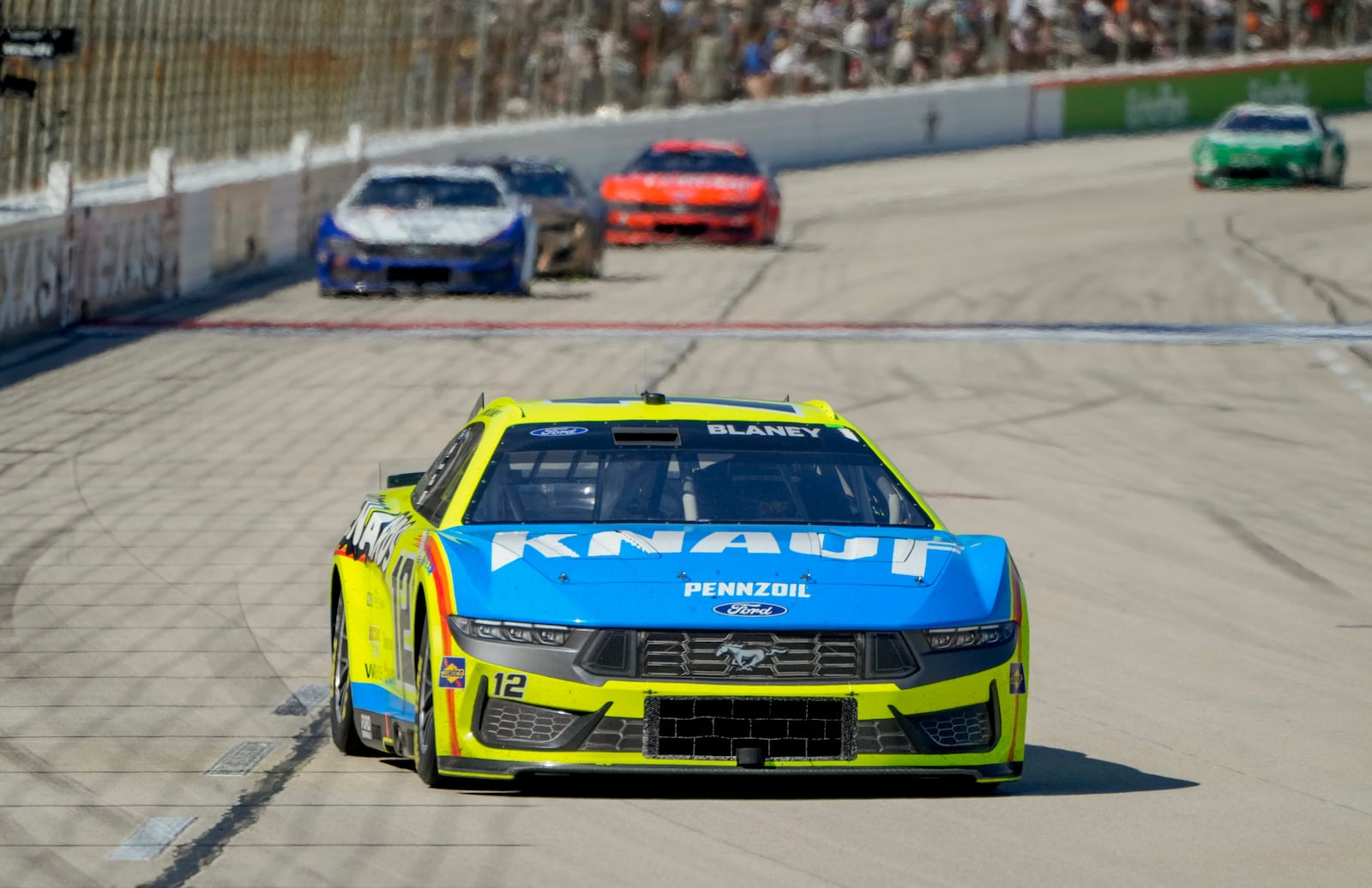 Ryan Blaney (12) heads into Turn 1 during a NASCAR Cup Series auto race at Texas Motor Speedway in Fort Worth, Texas, Sunday, May 4, 2025. (AP Photo/Larry Papke)