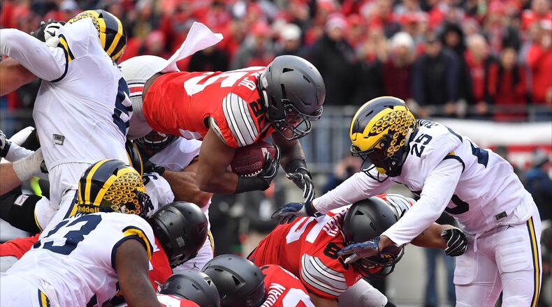 COLUMBUS, OH - NOVEMBER 26: Mike Weber #25 of the Ohio State Buckeyes dives into the end zone for a touchdown during the second half against the Michigan Wolverines at Ohio Stadium on November 26, 2016 in Columbus, Ohio. (Photo by Jamie Sabau/Getty Images)