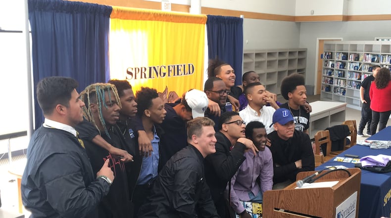 Springfield High School football players pose for a photo during a signing day ceremony at the school on Thursday. MARCUS HARTMAN/ STAFF