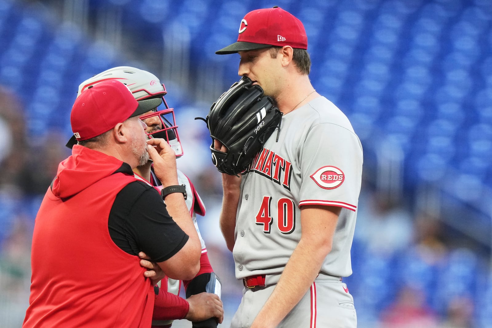 Cincinnati Reds starting pitcher Nick Lodolo (40) talks to pitching coach Derek Johnson, left, during the second inning of a baseball game against the Miami Marlins, Monday, April 21, 2025, in Miami. (AP Photo/Lynne Sladky)