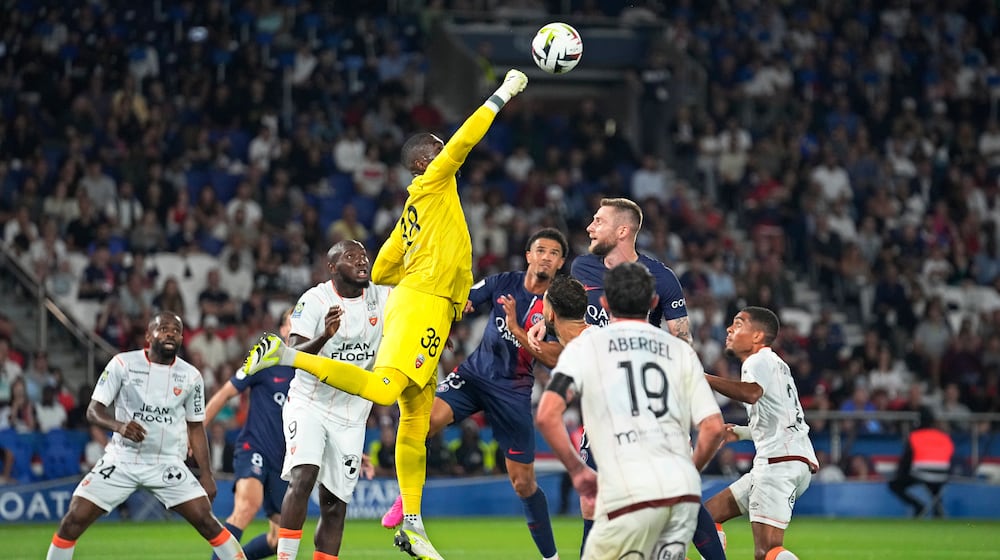 FILE - Lorient's goalkeeper Yvon-Lamdry Mvogo punches the ball clear during the French League One soccer match between Paris Saint-Germain and Lorient at the Parc des Princes stadium in Paris, Aug. 12, 2023. (AP Photo/Michel Euler, File)