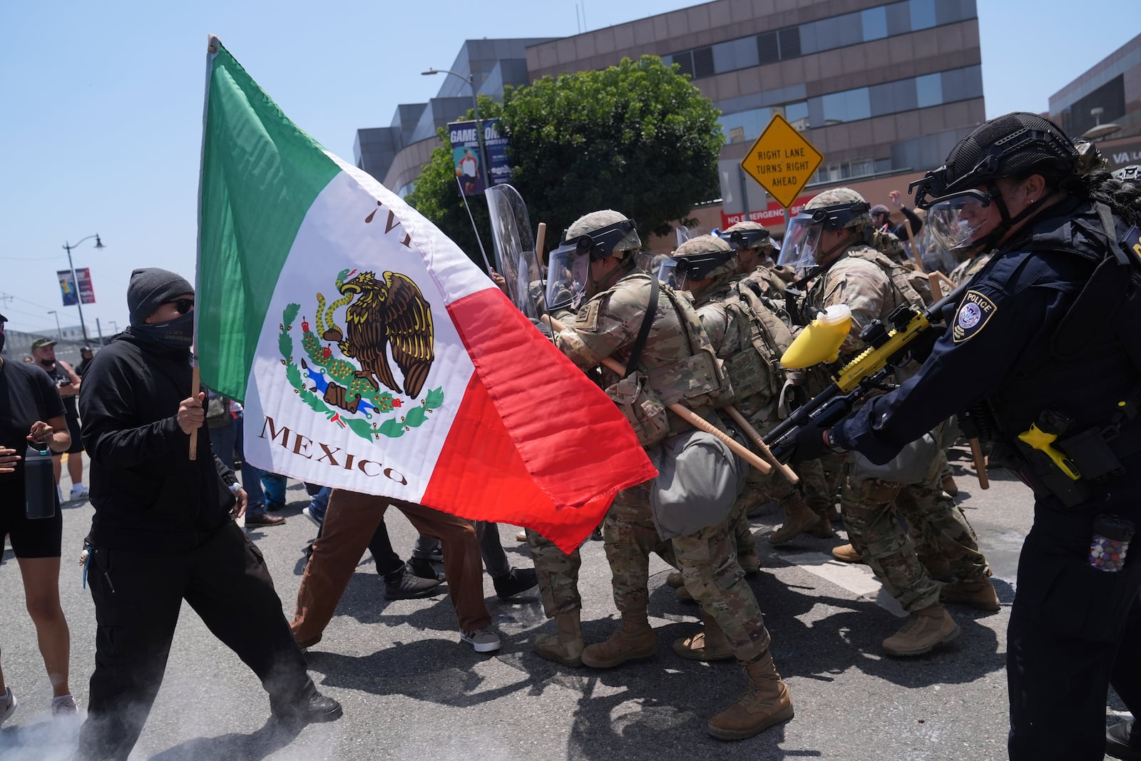 FILE - Protesters clash with authorities in downtown Los Angeles, Sunday, June 8, 2025, following last night's immigration raid protest. (AP Photo/Jae Hong, File)