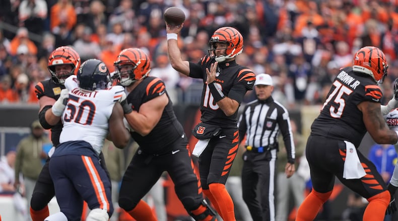 Cincinnati Bengals quarterback Joe Flacco (16) passes for a first down during the first half of an NFL football game against the Chicago Bears, Sunday, Nov. 2, 2025, in Cincinnati. (AP Photo/Joshua A. Bickel)