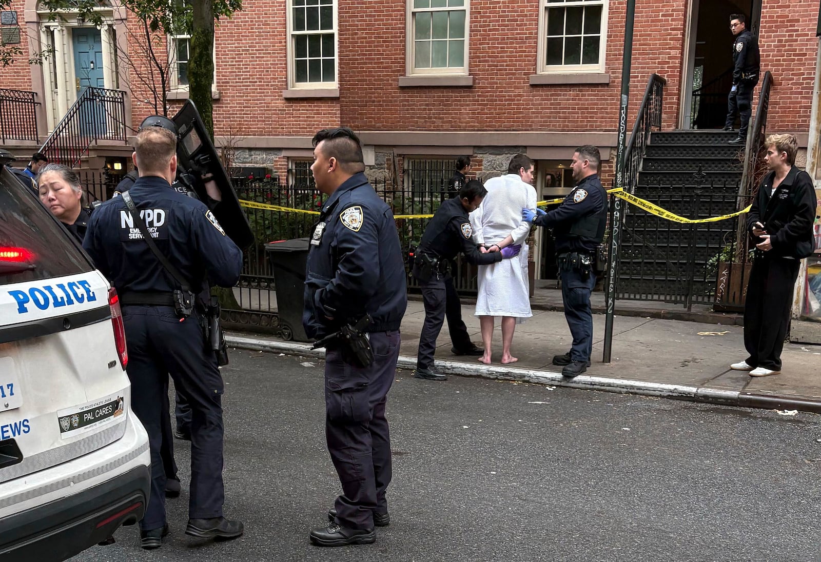 New York police officers arrest John Woeltz, Friday, May 23, 2025, in New York, who was charged with kidnapping, assaulting and holding a man against his will for several weeks in an upscale Manhattan town house.(AP Photo/Kava Gorna via AP)