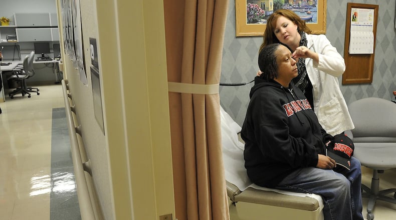 Heather Vince, nurse manager at the Springfield Community Based Outpatient Clinic, operated by the Department of Veterans Affairs, examines Myra Gaskins in 2013. Gaskins is a Desert Storm veteran from Springfield. Bill Lackey/Staff