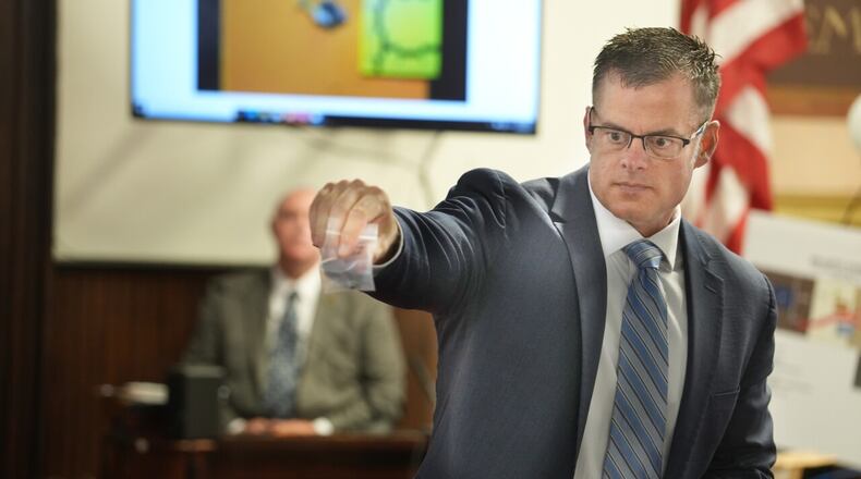 U.S. Attorney D. Andrew Wilson holds a bullet during testimony in the murder trial of George Wagner IV, 30, in Pike County Common Pleas Court in Waverly, Ohio, Friday, Sept 16, 2022. Behind Wilson is BCI agent Shane Harshaw. Wagner is charged with 22 counts, eight of them aggravated murder, in connection with the deaths of seven members of Pike County's Rhoden family and one future member on April 21-22, 2016. DORAL CHENOWETH/THE COLUMBUS DISPATCH