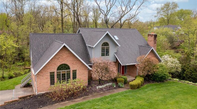 The front of this two-story home features a concrete walk anda  three-car attached, side-entry garage and covered front porch. Contributed photos