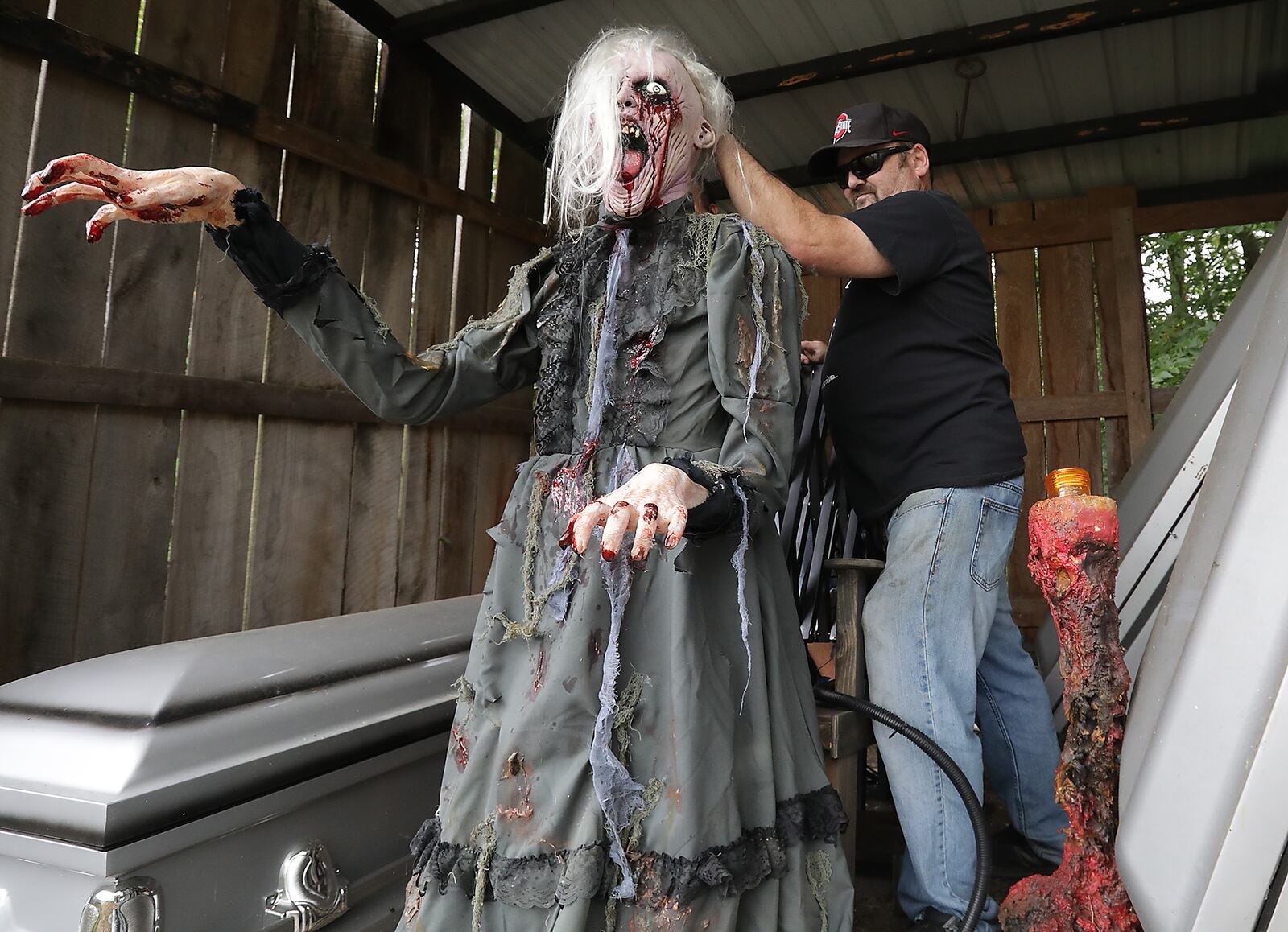 Paul Deady sets up an animatronic figure as he works on the Terror Maze Friday. BILL LACKEY/STAFF