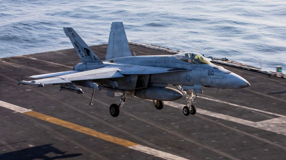 This image provided by U.S. Central Command shows a F/A-18E Super Hornet coming in for an arrested landing on USS Abraham Lincoln (CVN 72) after flying in support of Operation Epic Fury, on Saturday, Feb. 28, 2026. (U.S. Navy via AP)