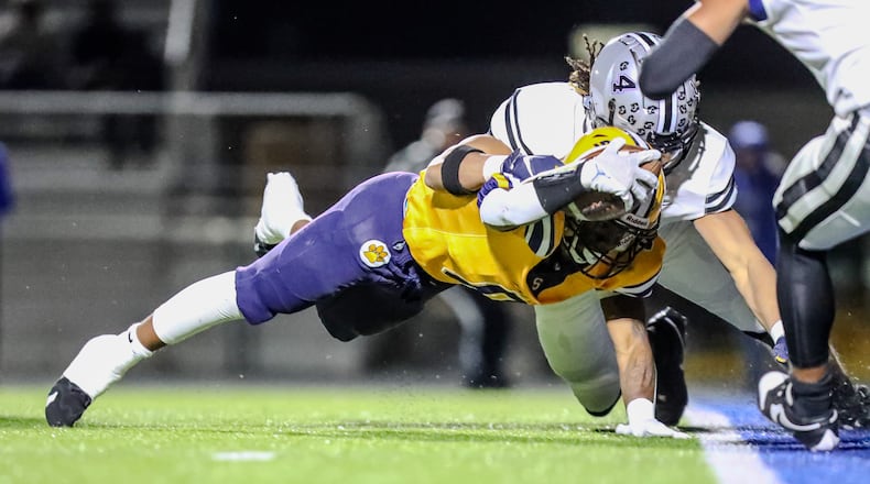 Springfield High School junior Deontre Long leaps for the goalline during their game against Hilliard Bradley on Friday night in Springfield. Long scored on the play, but the Wildcats fell 34-30. Michael Cooper/CONTRIBUTED