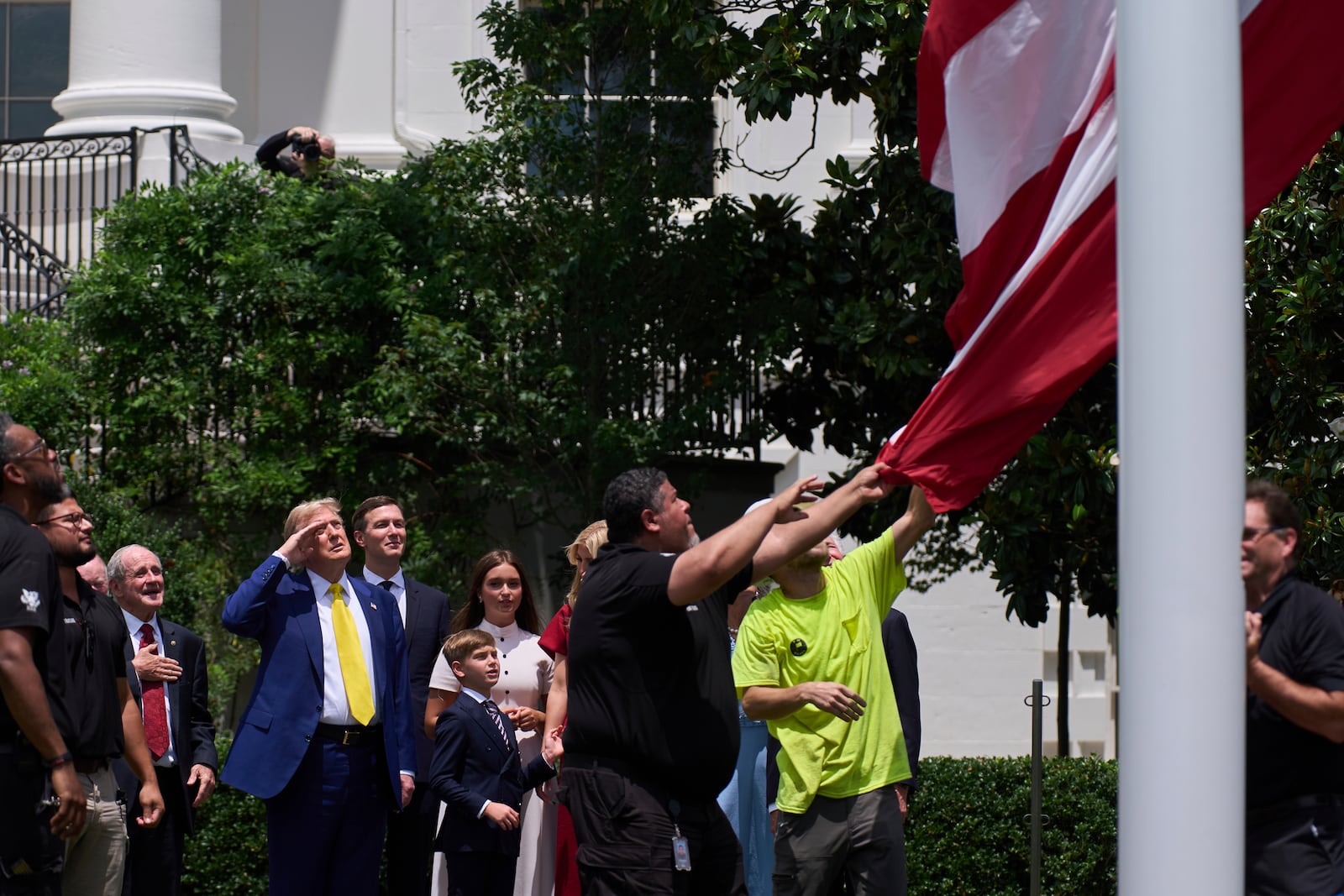 President Donald Trump salutes as a flag is raised on the South Lawn of the White House, Wednesday, June 18, 2025, in Washington. (AP Photo/Evan Vucci)