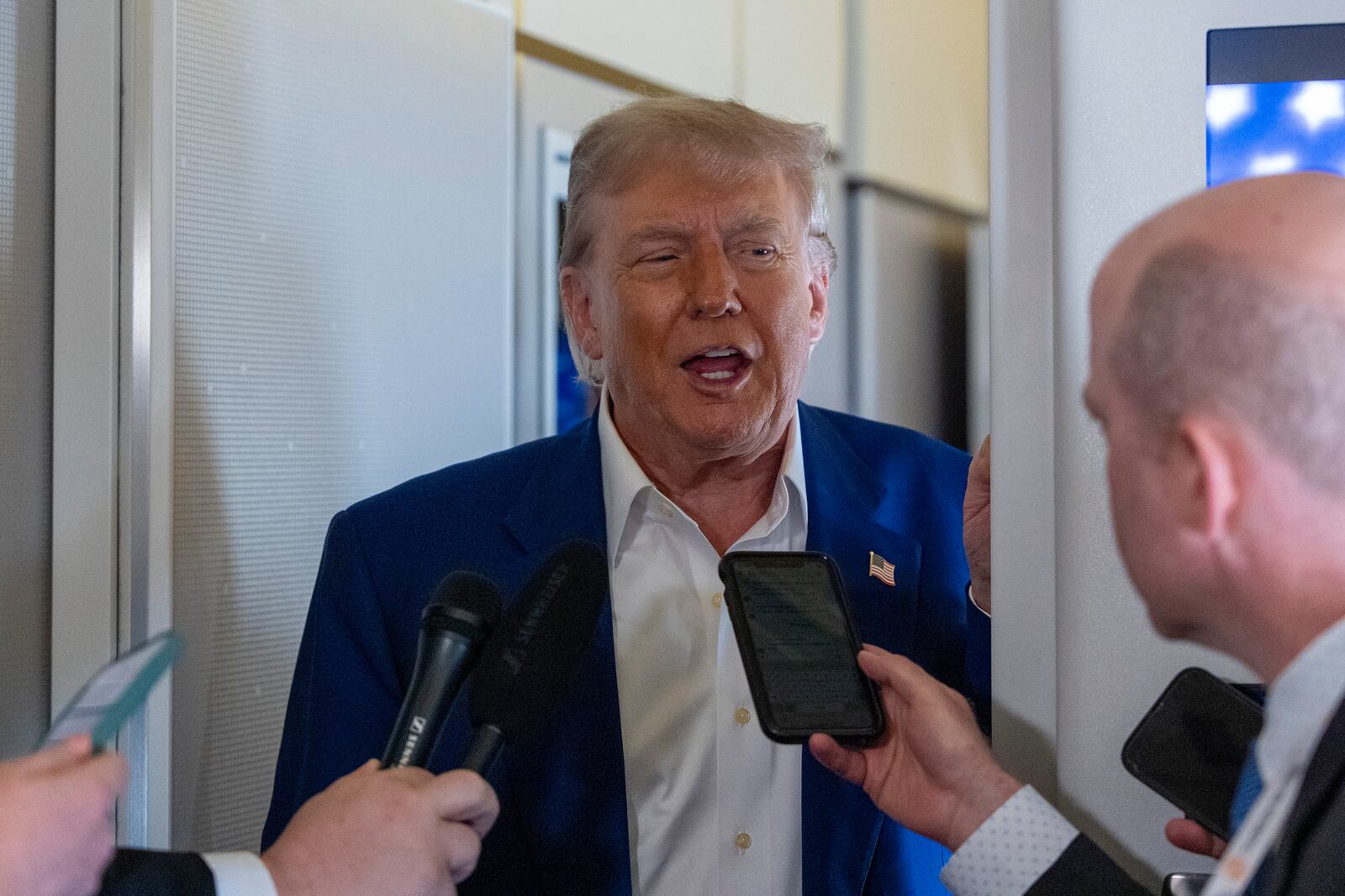 President Donald Trump speaks with reporters on Air Force One while in flight from Joint Base Andrews, Md., to Amsterdam, Netherlands, Tuesday, June 24, 2025. (AP Photo/Alex Brandon)