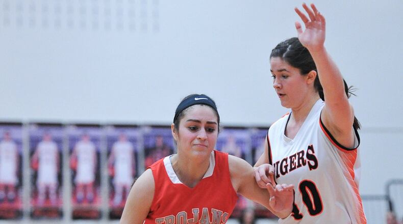 Southeastern’s Leslie Flores dribbles with pressure from West Liberty-Salem’s Paige Shafer during an Ohio Heritage conference game Saturday night in West Liberty. BRYANT BILLING / CONTRIBUTED