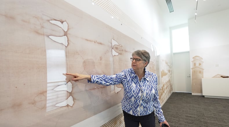 Nora Creech, director of Othonia North America, points to a replica of the Shroud of Turin at a new interactive museum dedicated to the shroud, Monday, Nov. 17, 2025, at the Christ Cathedral campus in Garden Grove, Calif. (AP Photo/Krysta Fauria)