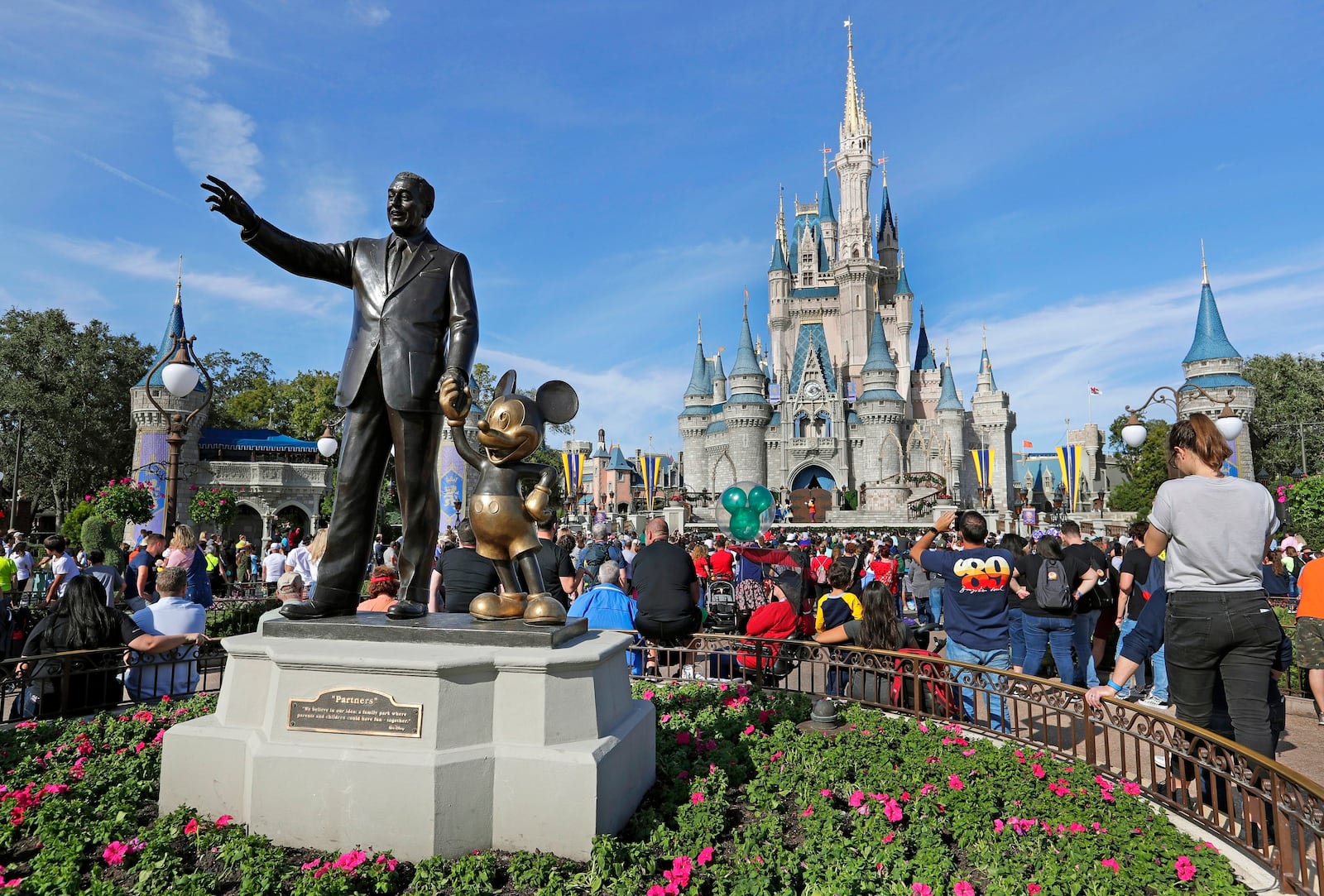 FILE - A statue of Walt Disney and Micky Mouse stands in front of the Cinderella Castle at the Magic Kingdom at Walt Disney World in Lake Buena Vista, Fla., Jan. 9, 2019. (AP Photo/John Raoux, File)