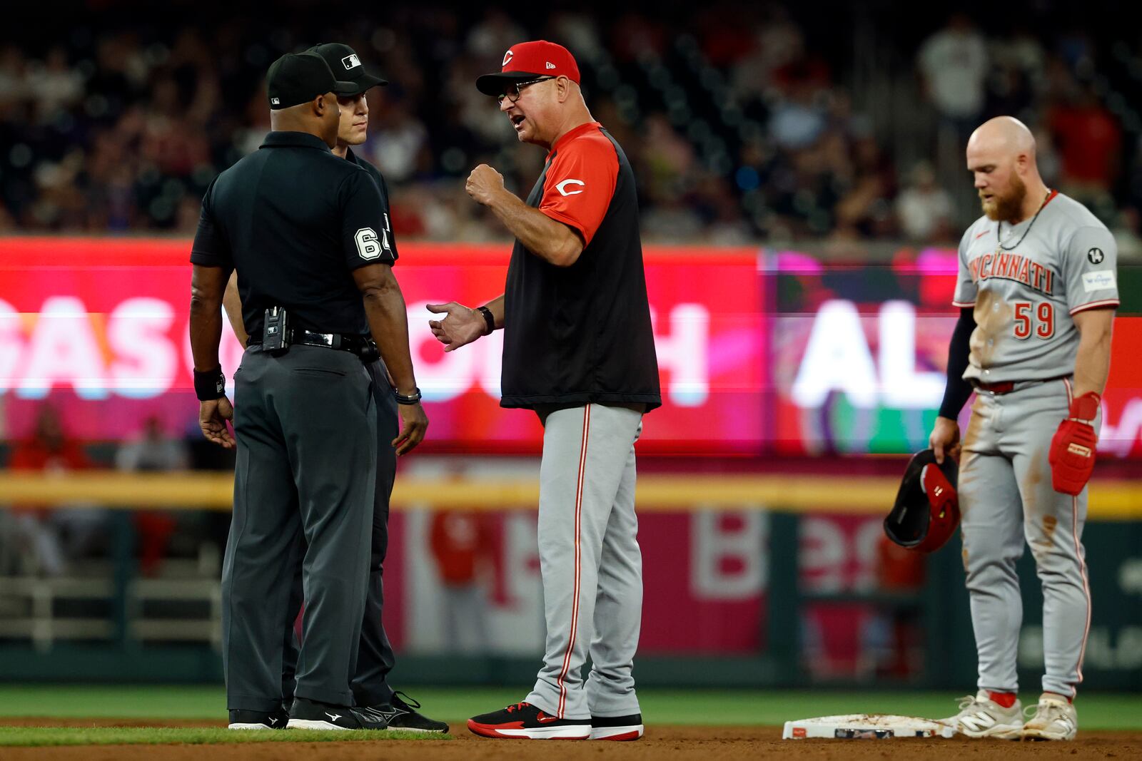 Cincinnati Reds manager Terry Francona argues a call with umpires during the 11th inning of a baseball game against the Atlanta Braves, Thursday, May 8, 2025, in Atlanta. (AP Photo/Butch Dill)