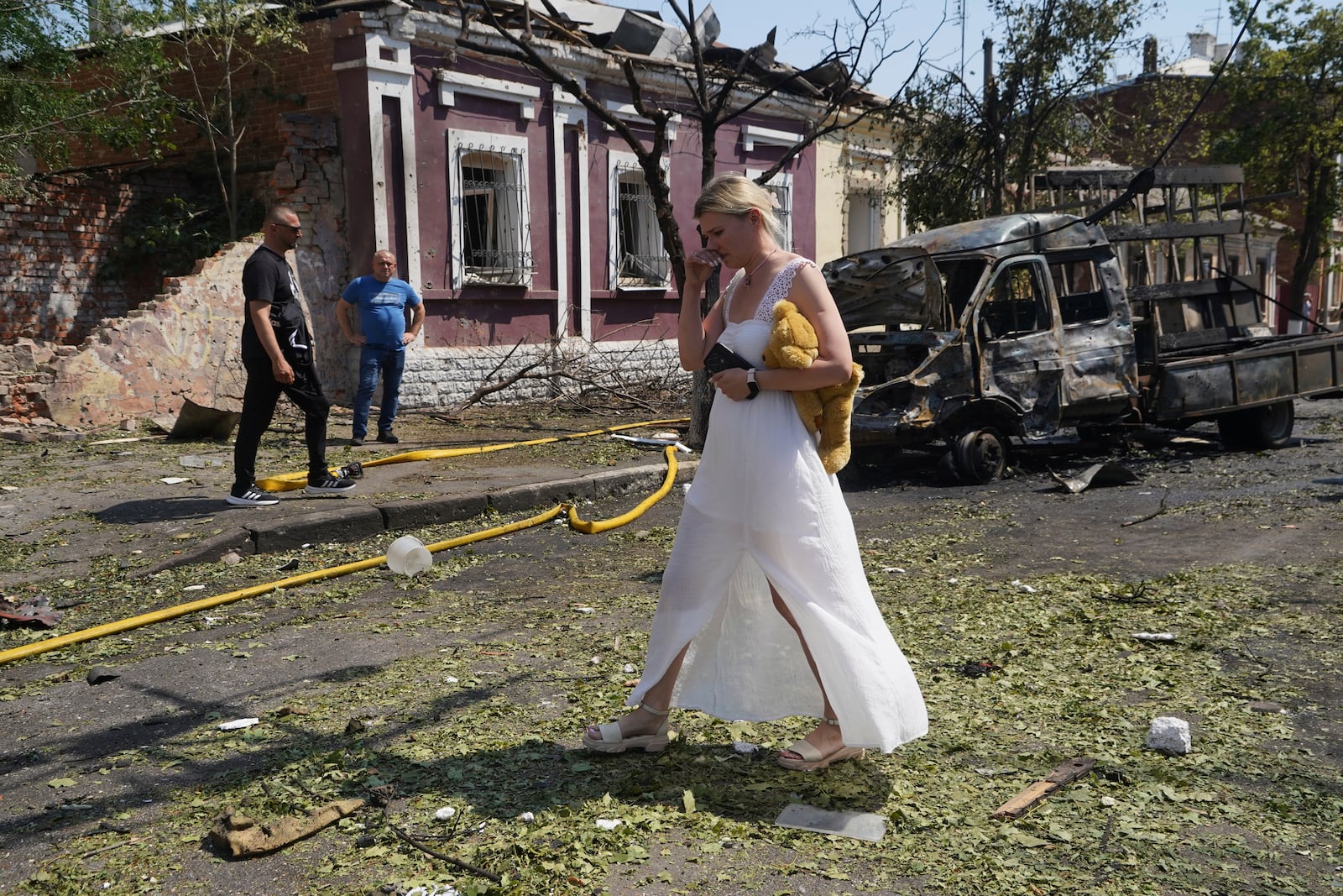 A woman reacts as she leaves her home that was destroyed by a Russian airstrike in Kharkiv, Ukraine, Monday, July 7, 2025. (AP Photo/Andrii Marienko)