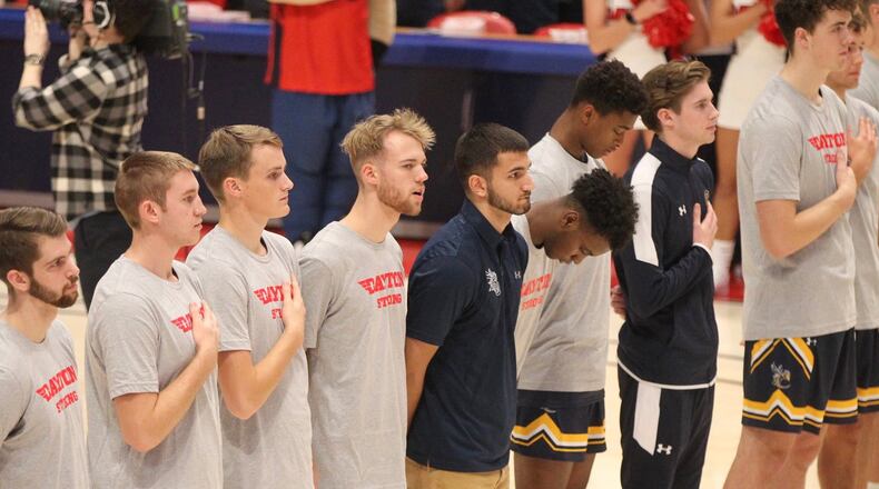 Cedarville players stand for the national anthem before an exhibition game against on Saturday, Nov. 2, 2019, at UD Arena. David Jablonski/Staff