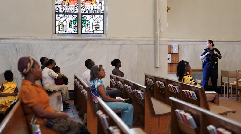 A Springfield police officer stands watch during a service in support of the Haitian community at St. Raphael Catholic church in Springfield, Ohio, Sunday, Sept. 15, 2024. (AP Photo/Jessie Wardarski)