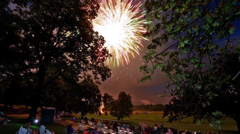 The rain stopped just in time for the Buck Creek Boom fireworks show to go on Monday, July 3, 2023 in Springfield. Spectators lined the shore of Buck Creek to watch the annual show put on by the National Trail Parks and Recreation District. BILL LACKEY/STAFF
