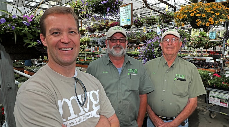 Jeff Pack, the new owner of Meadow View Growers, left, wants people to know that Scott, center, and Earl are still going to be around and working at the garden center. Bill Lackey/Staff
