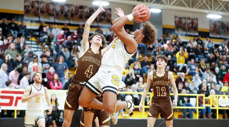 Shawnee High School junior Darian Dixon drives to the hoop while being defended by Kenton Ridge junior Canye Rogan during their game on Friday, Jan. 27 at Shawnee High School. The Braves won 50-38. Michael Cooper/CONTRIBUTED