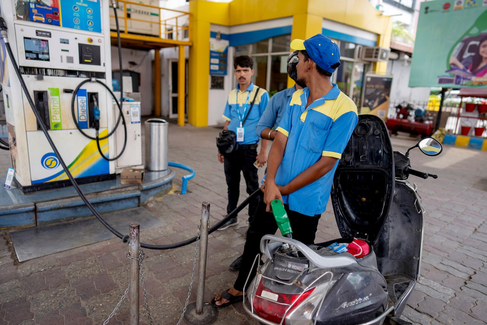 An Indian man fills petrol in a two wheeler at a fuel pump in Prayagraj, in the northern Indian state of Uttar Pradesh, Monday, May 5, 2025. (AP Photo/Rajesh Kumar Singh)